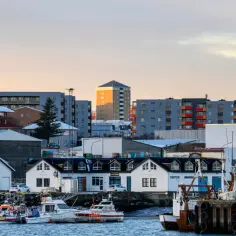 Port w Reykjaviku, gdzie statki czekają na kolejny dzień pracy. W tle nowoczesne budynki, symbol rozwoju i możliwości zatrudnienia. Islandia praca czeka!